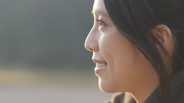 Side profile of woman smiling