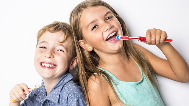 brother and sister washing thier teeth